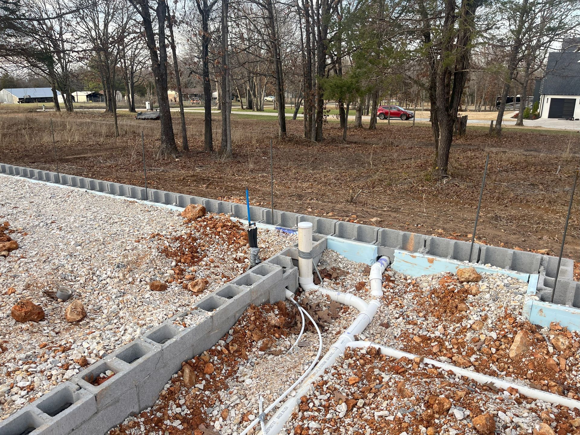A construction site with a lot of concrete blocks and pipes