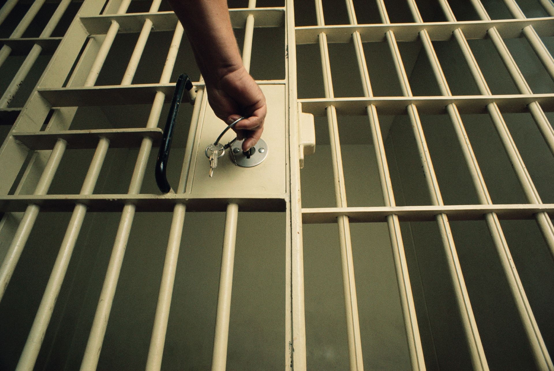 Man Using A Key To Open A Jail Cell — Land O Lakes, FL — Brad’s Bail Bonds