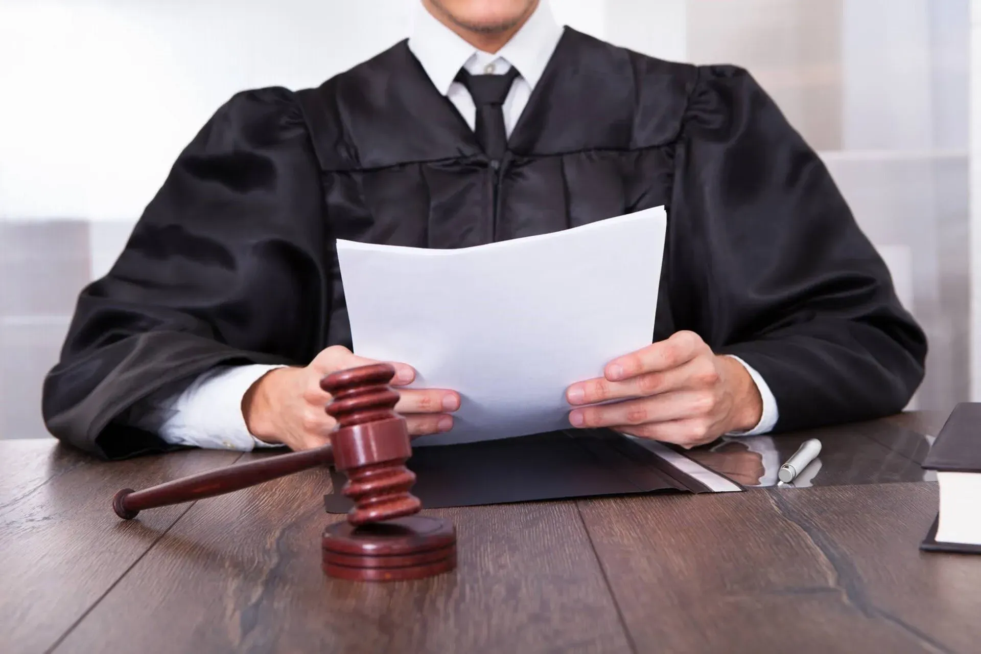 Judge Holding Document Paper Beside Gavel — New Port Richey, FL — Brad’s Bail Bonds
