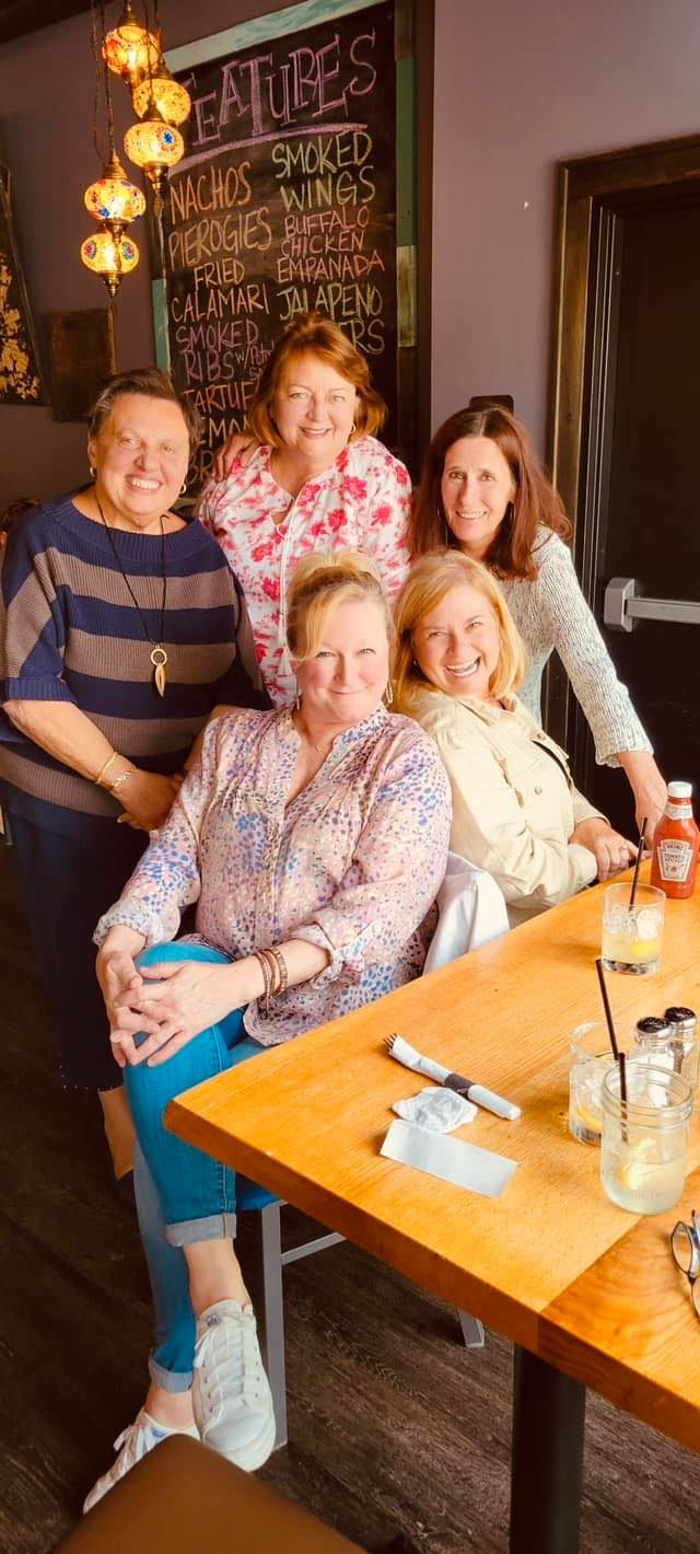 A group of women are sitting at a table in a restaurant.