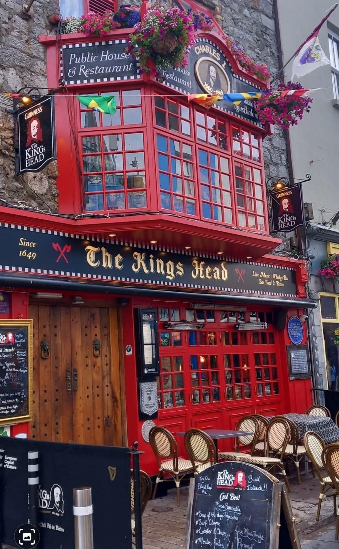 A red building with a sign that says the kings head