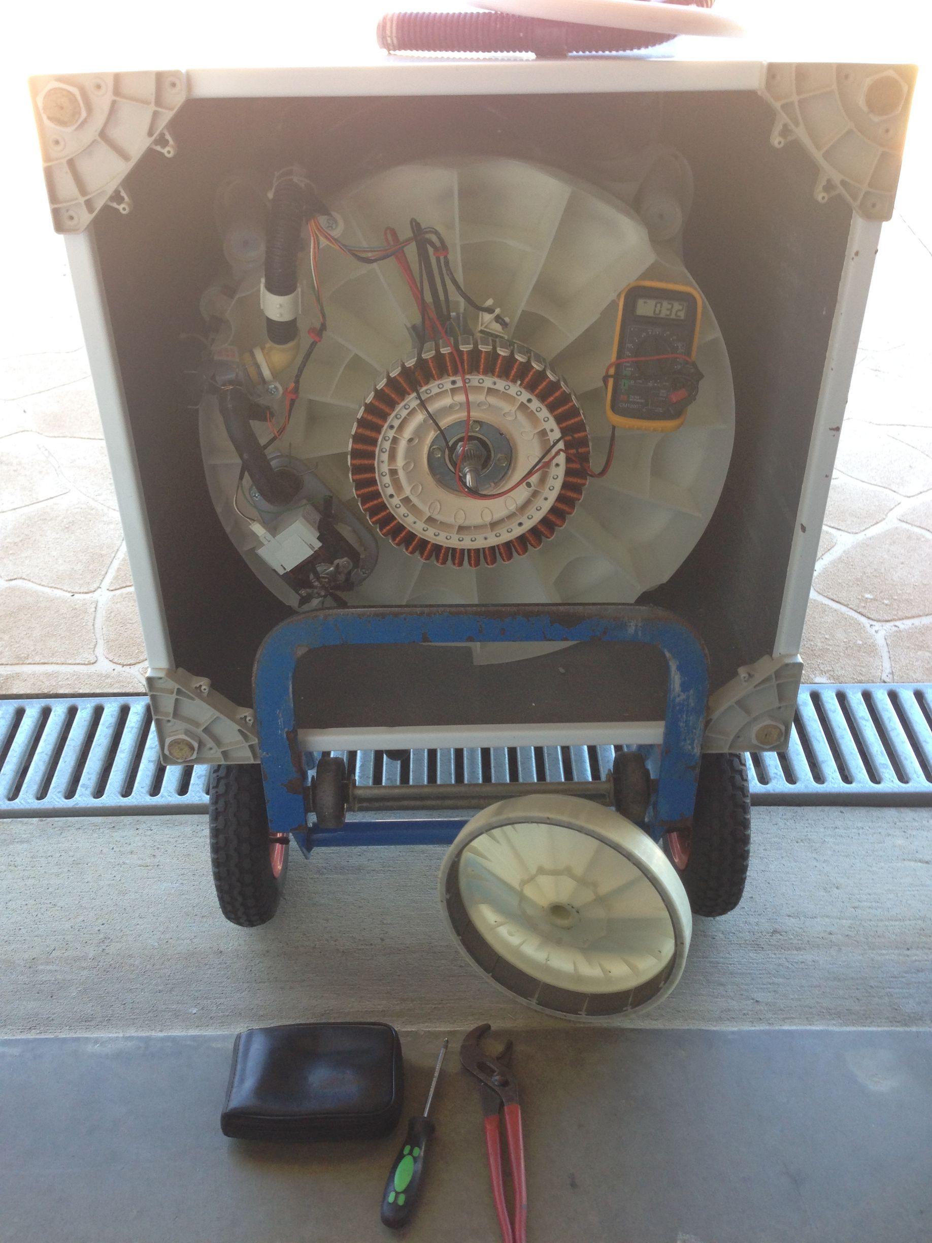 Washing machine disassembled on a wheeled cart; tools and parts in front — A.S.A.P. Appliance Service & Sales in Hamlyn Terrace, NSW