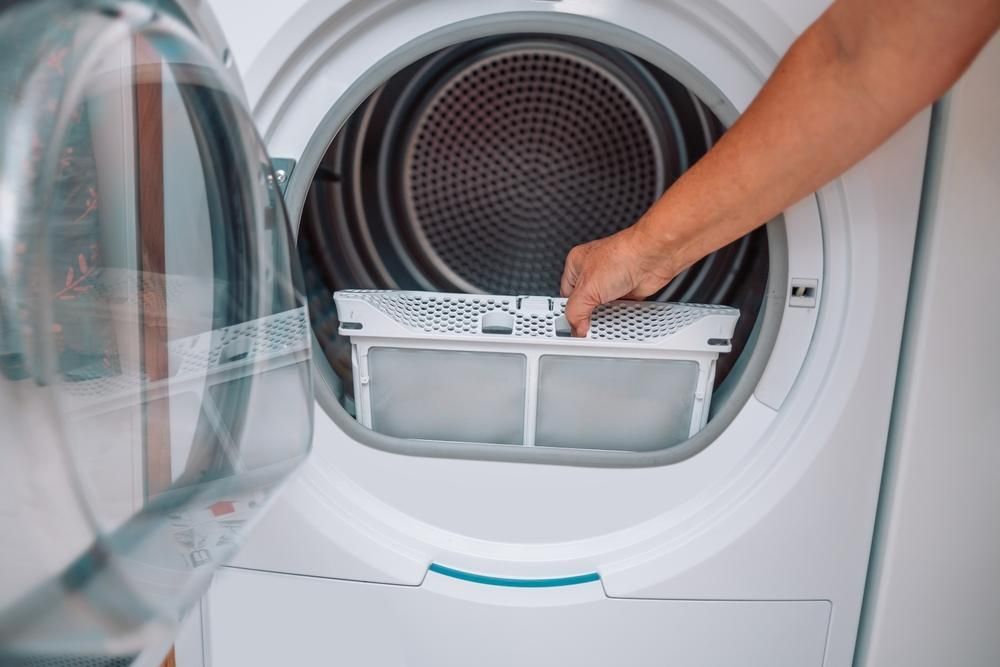A Person is Fixing a Washing Machine With Their Hands — A.S.A.P. Appliance Service & Sales in Lake Macquarie, NSW