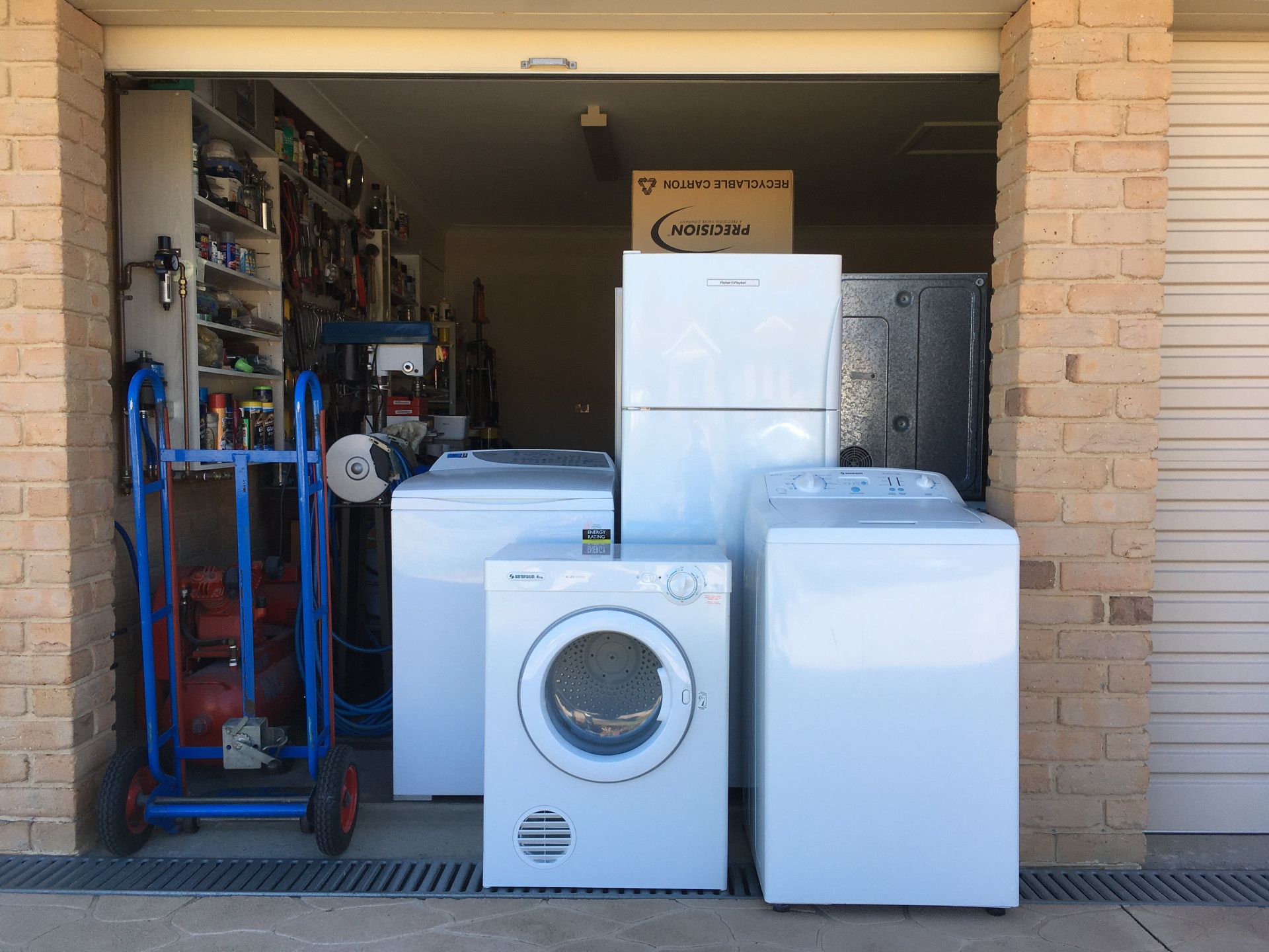 Appliances outside garage: refrigerator, dryer, two washing machines — A.S.A.P. Appliance Service & Sales in Wyong, NSW