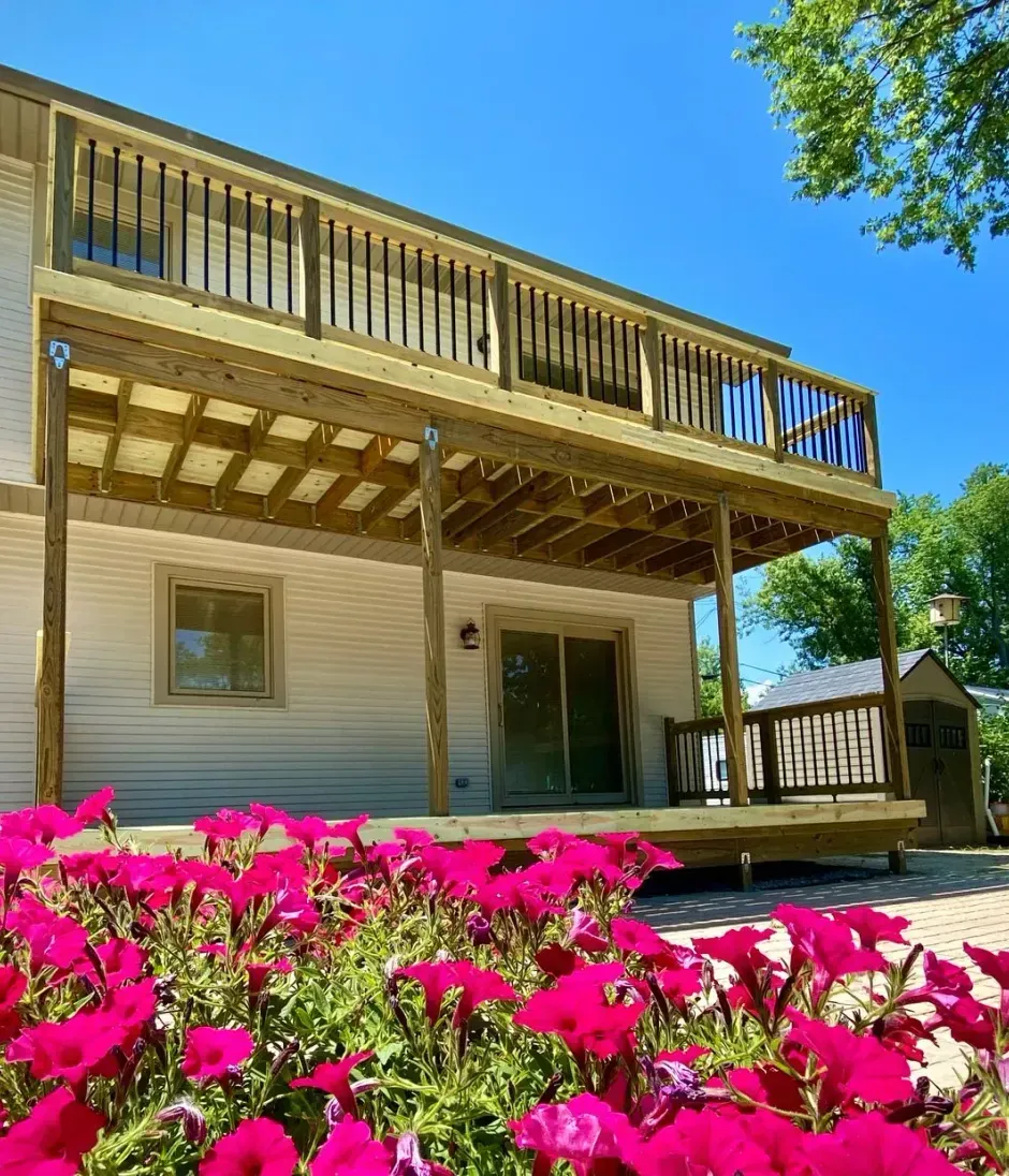 A wooden porch with stairs leading up to it