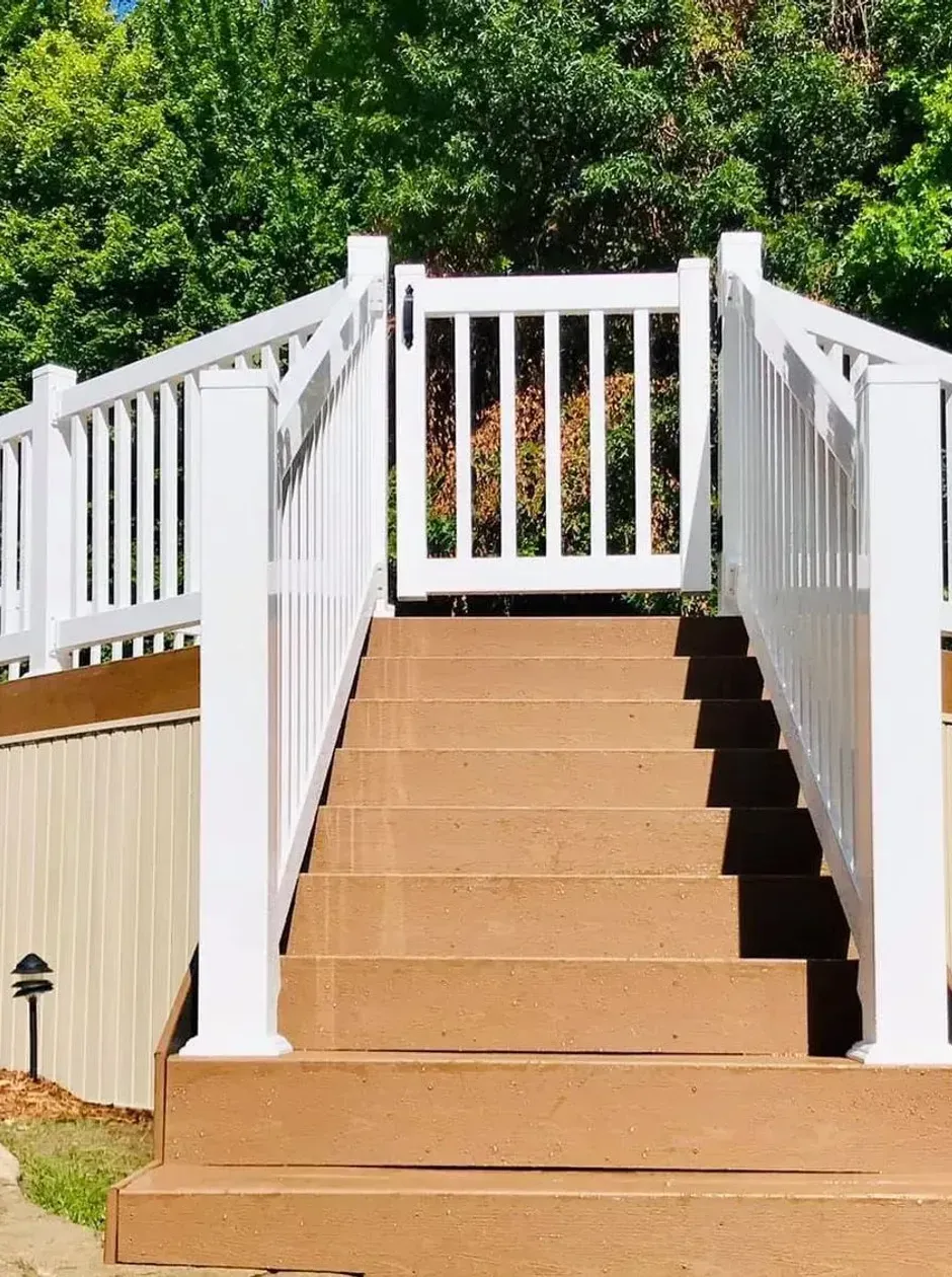 A wooden deck with a couch and chairs on it