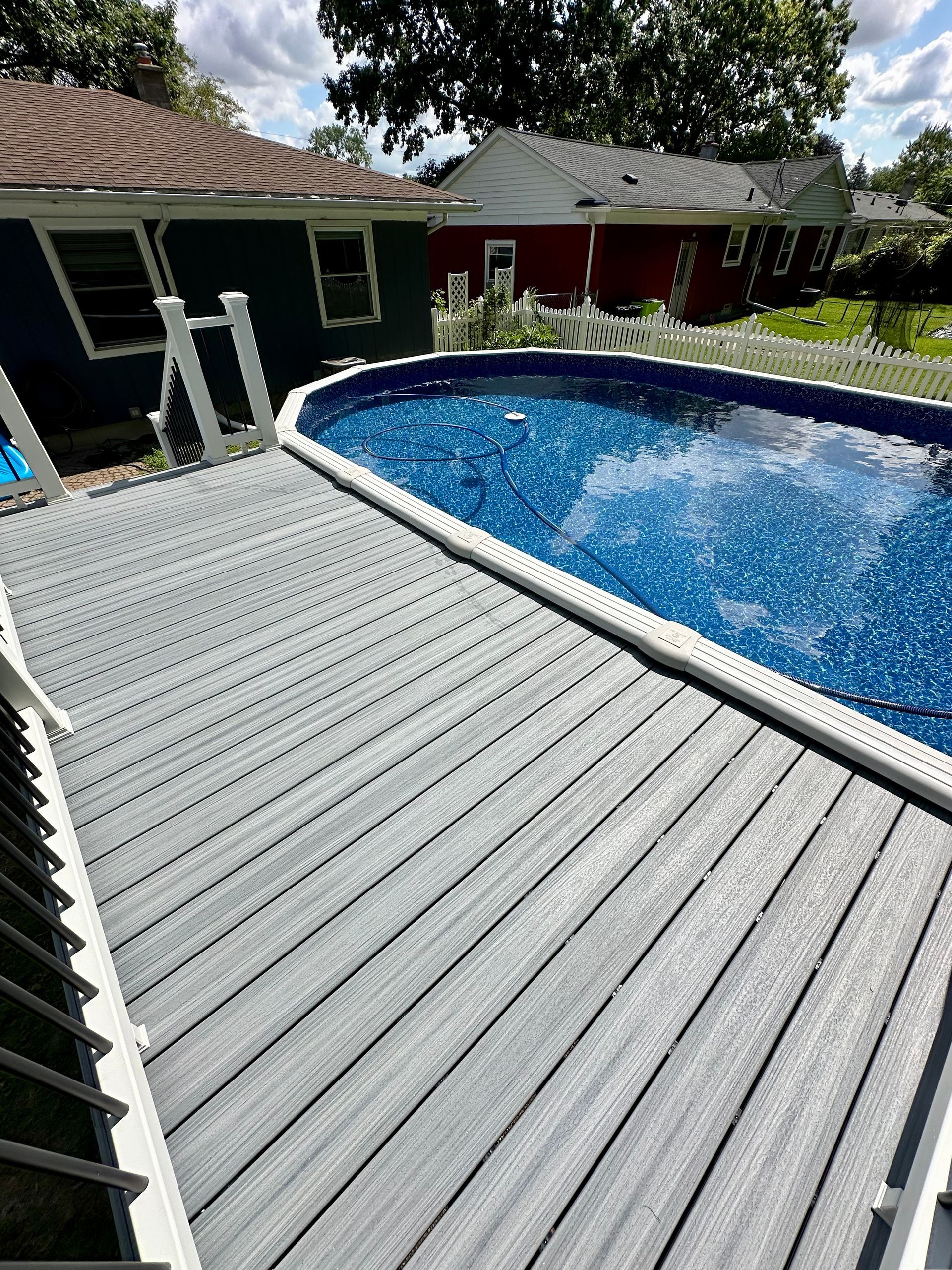 A wooden deck with a couch and chairs on it