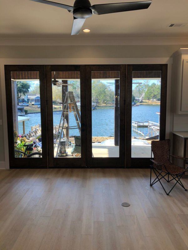 A living room with sliding glass doors and a ceiling fan.