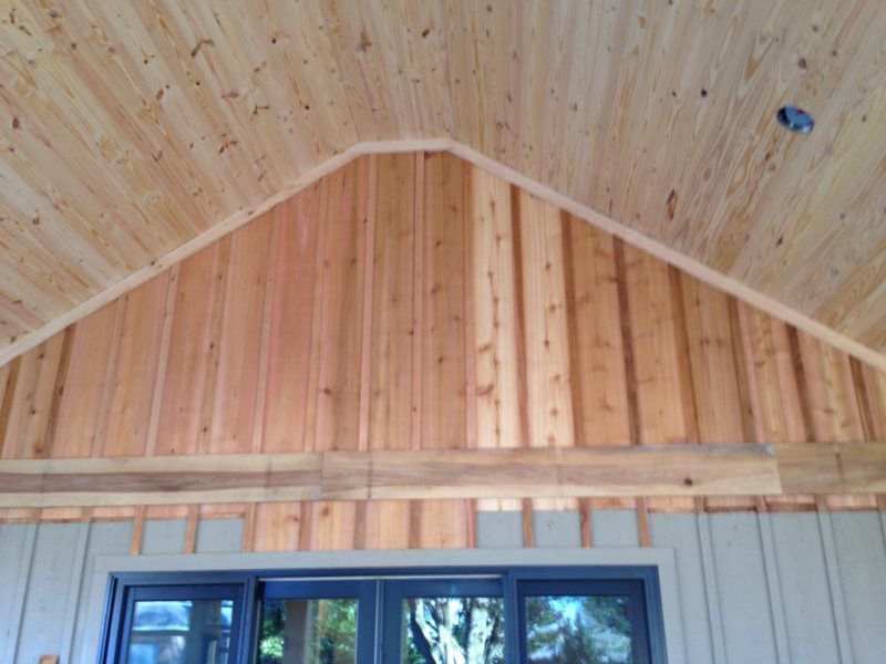 A room with a wooden ceiling and a window.