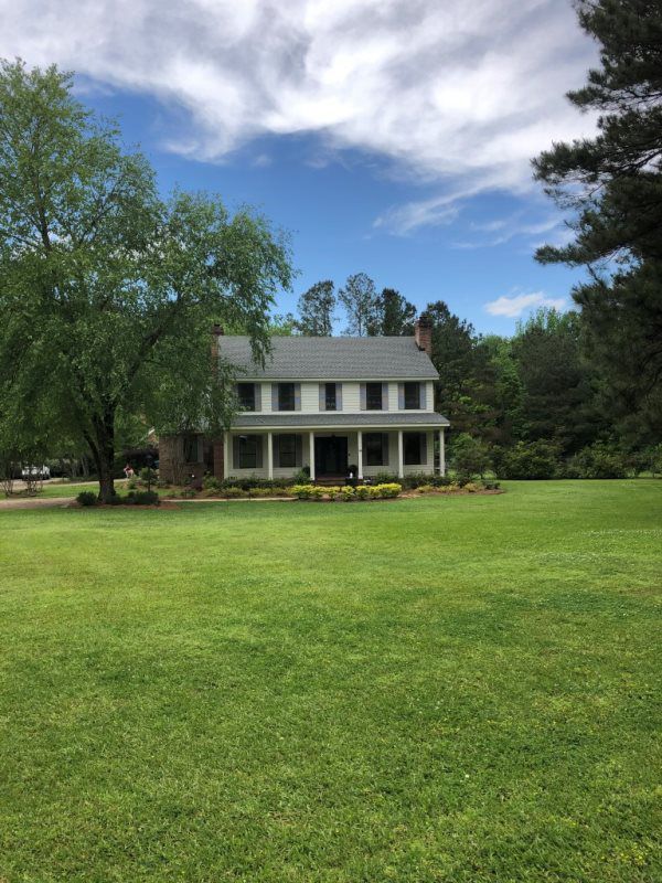A large house with a large lawn in front of it