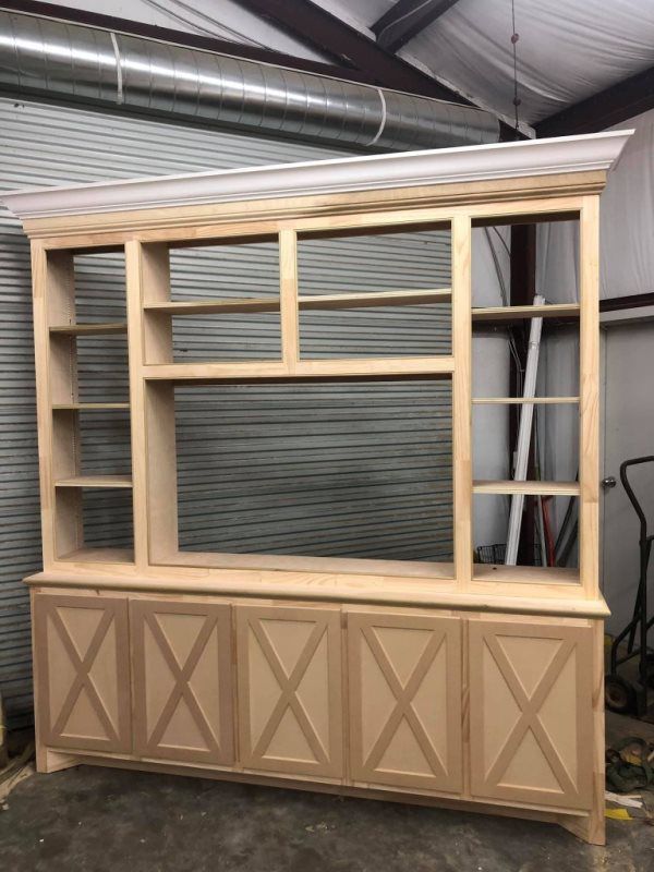 A large wooden cabinet with a lot of shelves and drawers