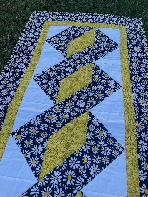 Daisy Quilt With Black, White, and Yellow Diamonds, on Green Grass — Lyn-Jelle Crafts in Emu Park, QLD