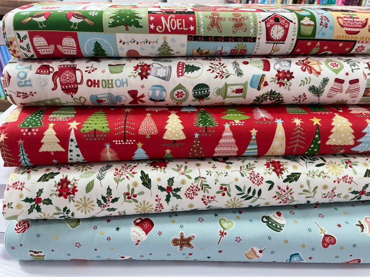 There Are Many Different Types of Christmas Fabrics Stacked — Lyn-Jelle Crafts in Emu Park, QLD