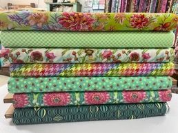 A Stack of Colorful Fabrics Sitting on Top of Each Other on a Table — Lyn-Jelle Crafts in Emu Park, QLD