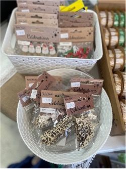 A Bowl of Christmas Decorations is Sitting on a Table Next to a Basket of Decorations — Lyn-Jelle Crafts in Emu Park, QLD