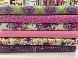 A Stack of Pink and Purple Fabrics Sitting on Top of Each Other on a Table — Lyn-Jelle Crafts in Emu Park, QLD