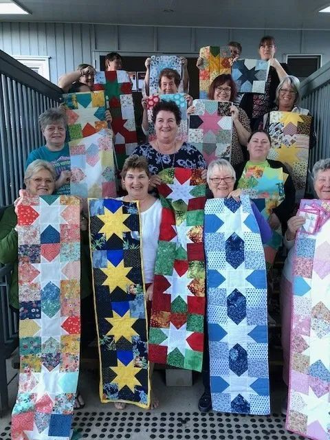 People Holding Quilts — Arts & Crafts in Emu Park, QLD