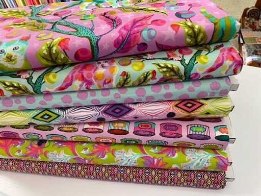 A Stack of Colorful Fabrics on a Table — Lyn-Jelle Crafts in Emu Park, QLD