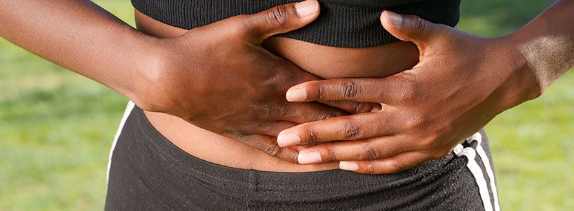 woman holding stomach in pain