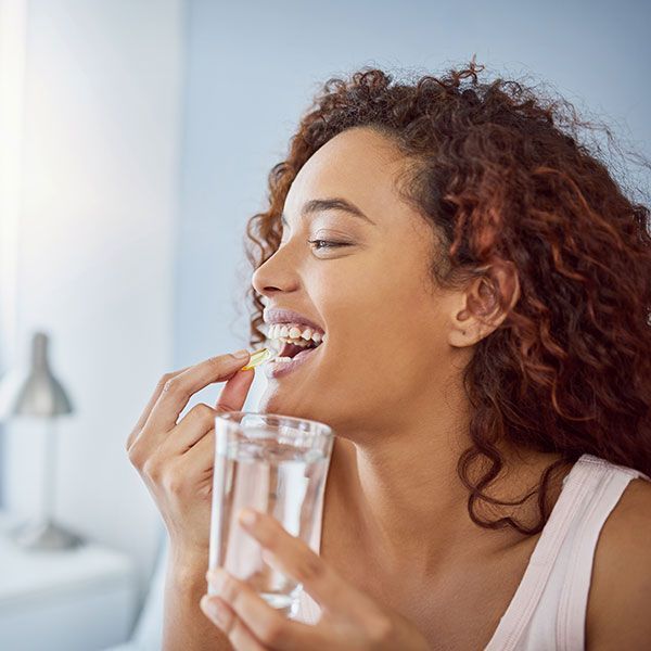 Woman taking a supplement