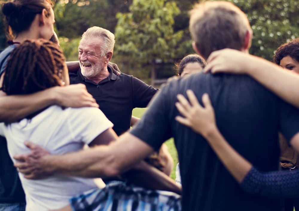 A group of people are hugging each other in a circle.