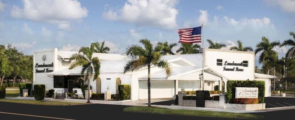 A room filled with coffins and flowers in a funeral home.