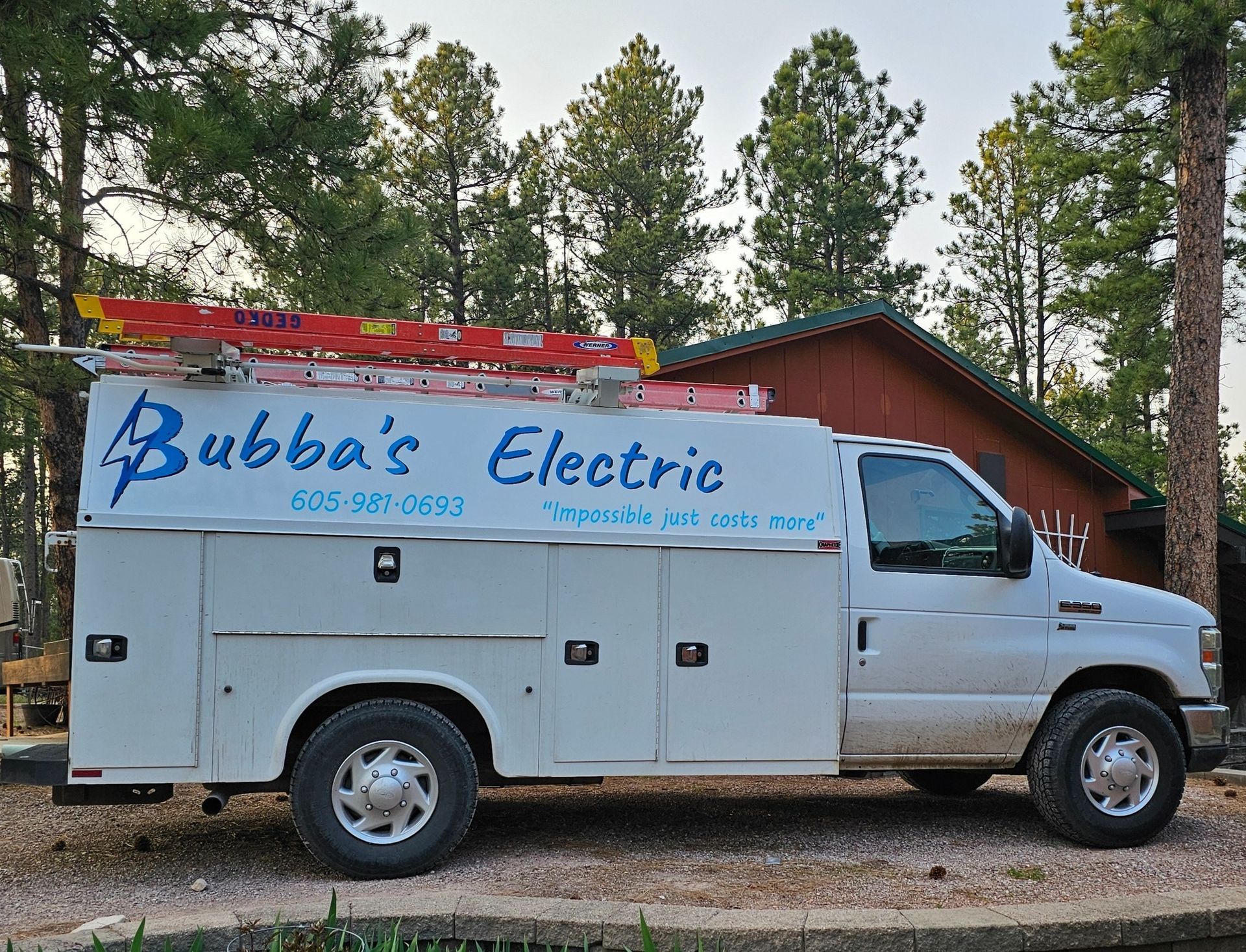 A bubba 's electric truck is parked in front of a house