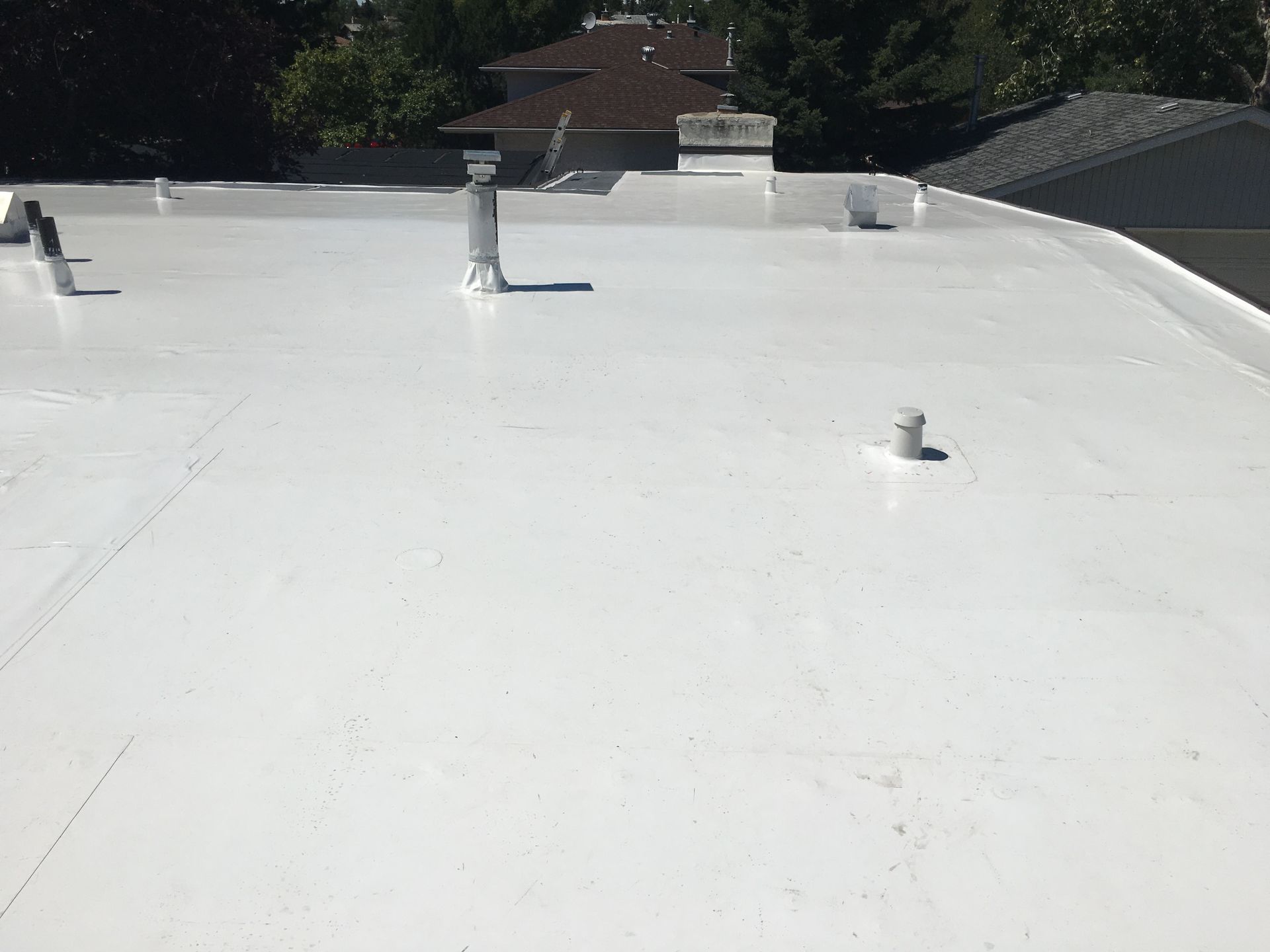 Torch On SBS roofing installation on a flat roof, showcasing the application process and finished su