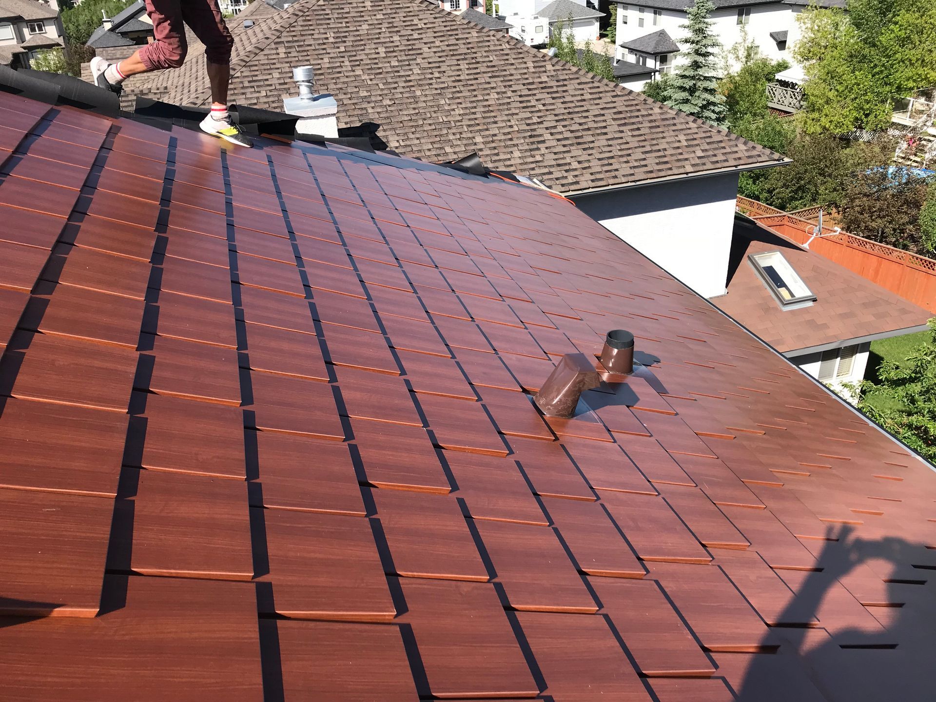 Calgary roofing team expertly installing a new roof on a sunny day.