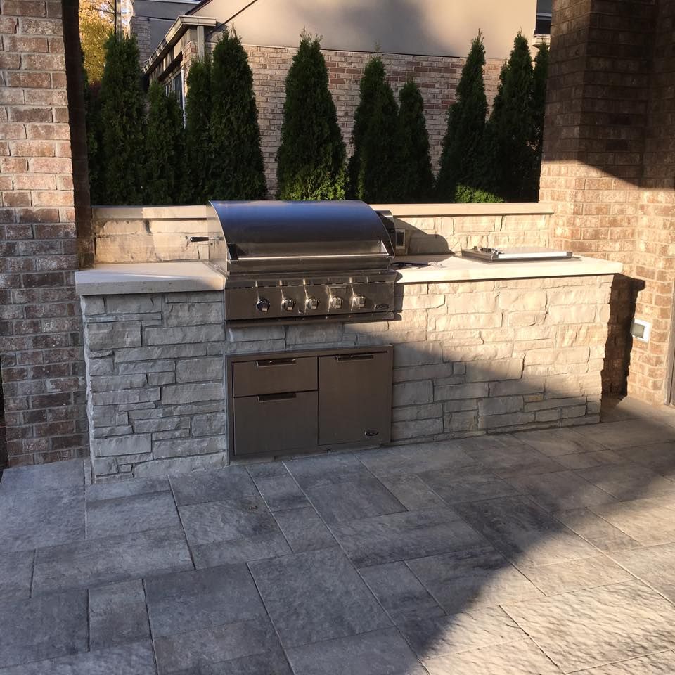 A brick wall with a grill in the middle of it