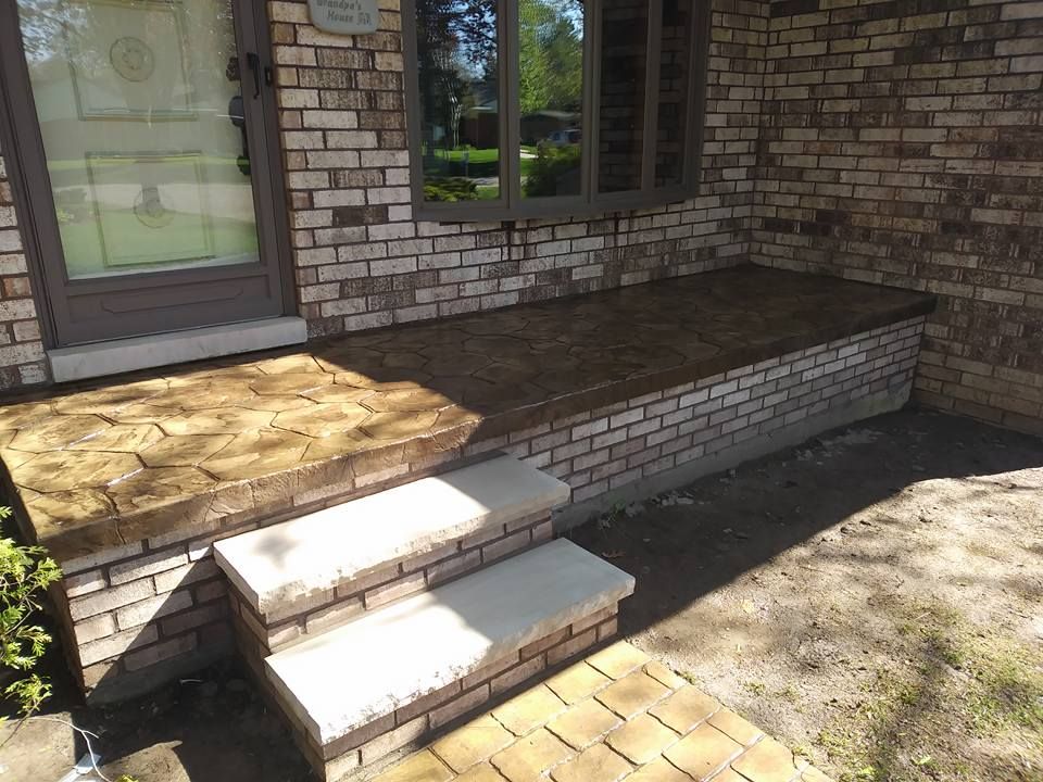 A brick porch with steps and a window