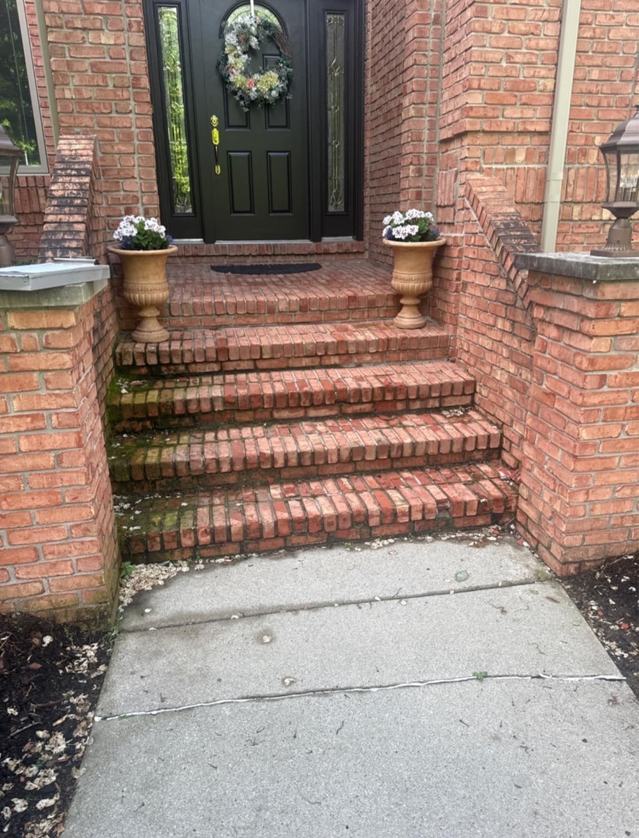 A brick walkway leading to the front door of a house.