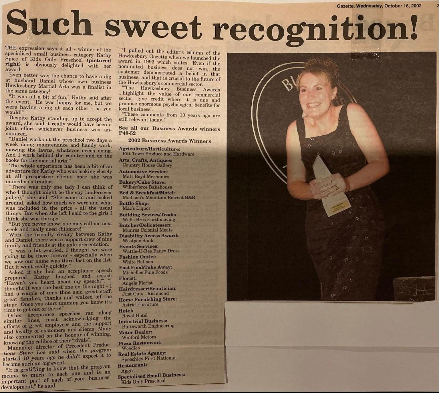 Newspaper clipping with headline āSuch sweet recognition!ā and a photo of a smiling award recipient holding a plaque.