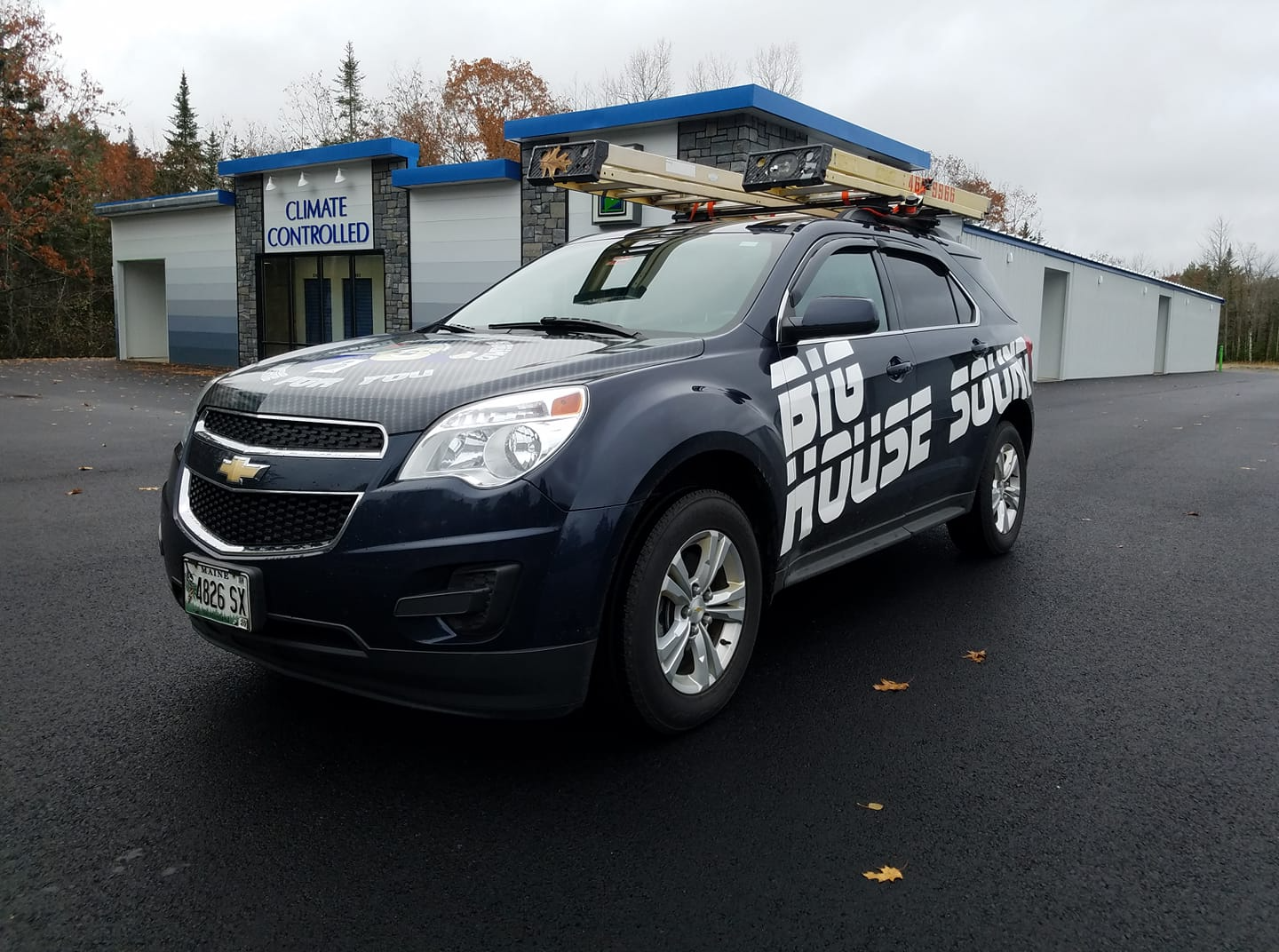 A chevrolet equinox suv is parked in front of a building.