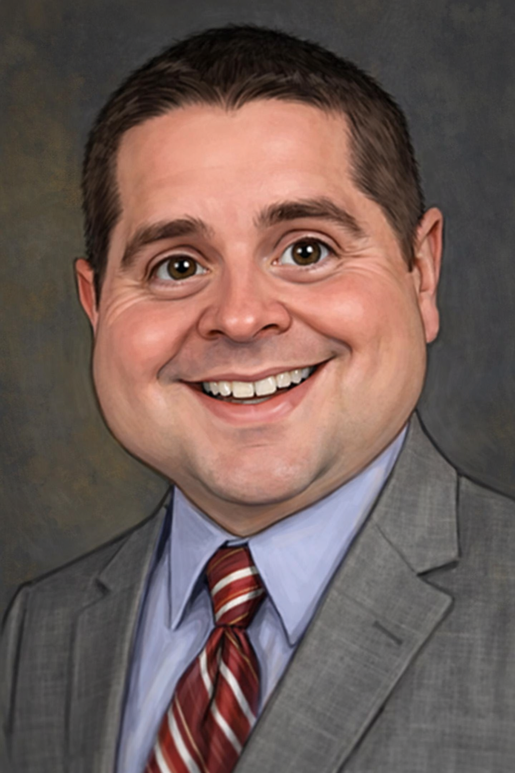 Man with gray hair and beard, wearing a suit and tie, against a blue background.