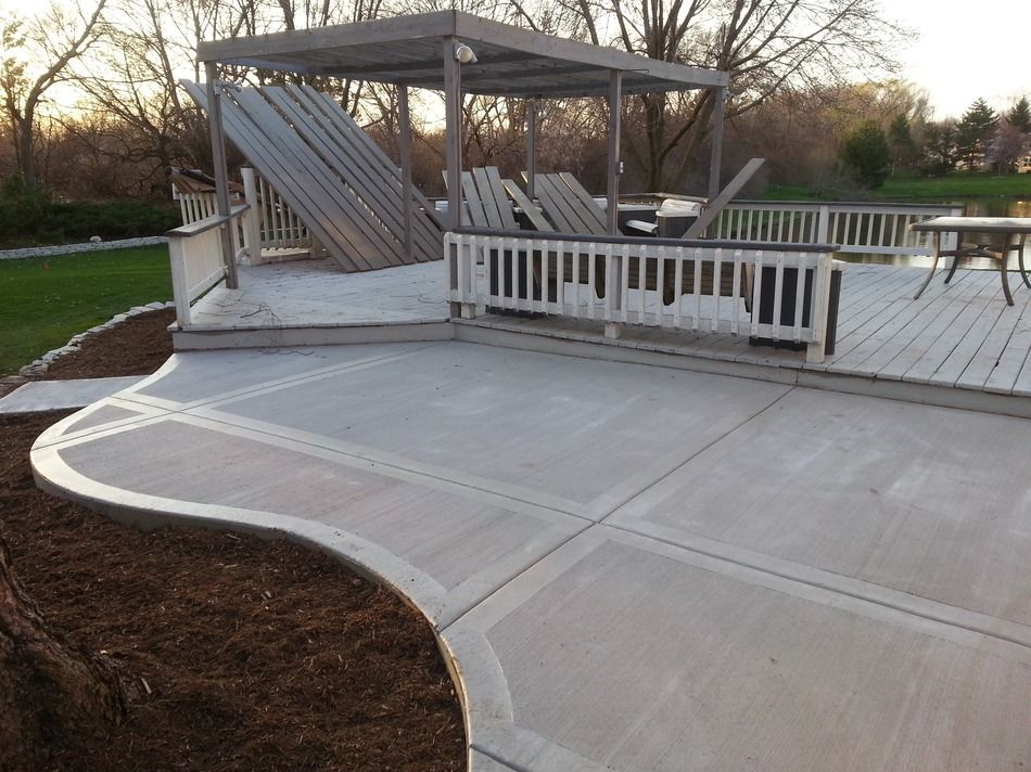 A patio with a gazebo and chairs on it