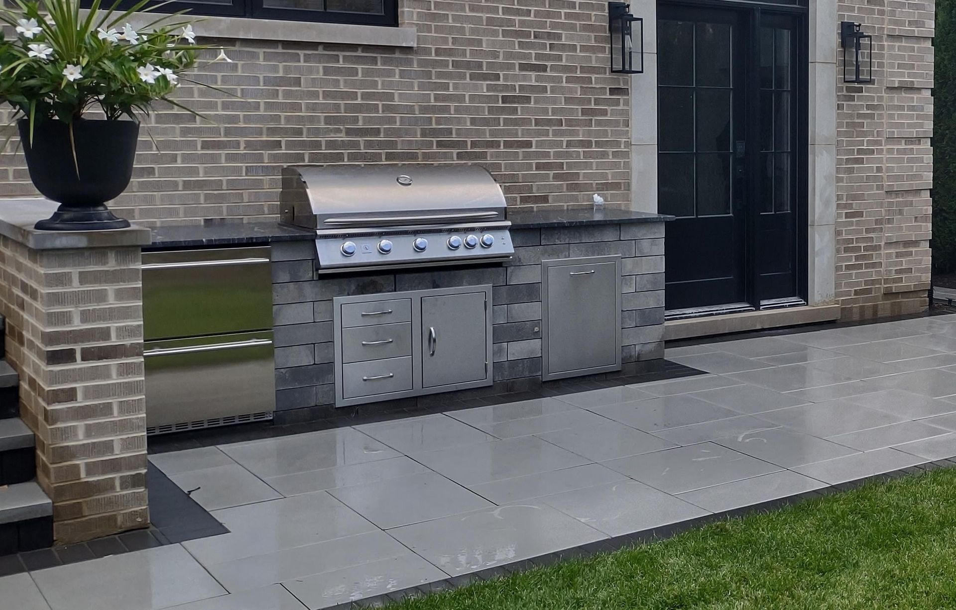 A brick building with a grill in front of it.