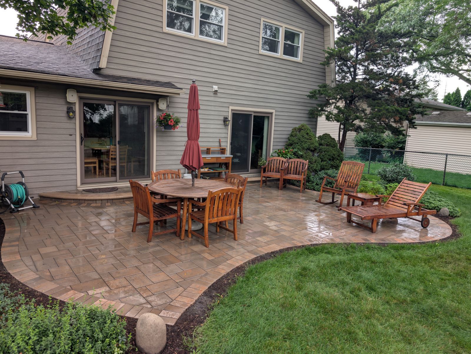 Newly poured concrete driveway in front of a house, blocked off with yellow caution tape.