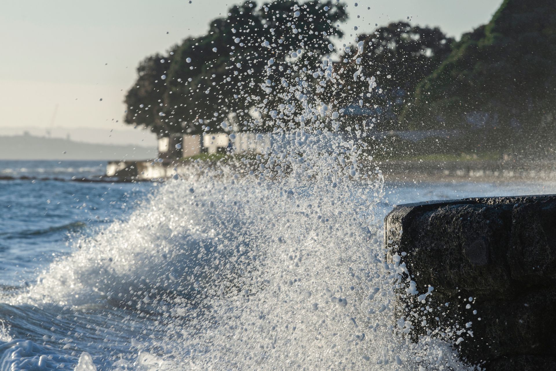 Close-up of a concrete seawall as it breaks waves from the sea. Close-up of a concrete seawall as it breaks waves from the sea.