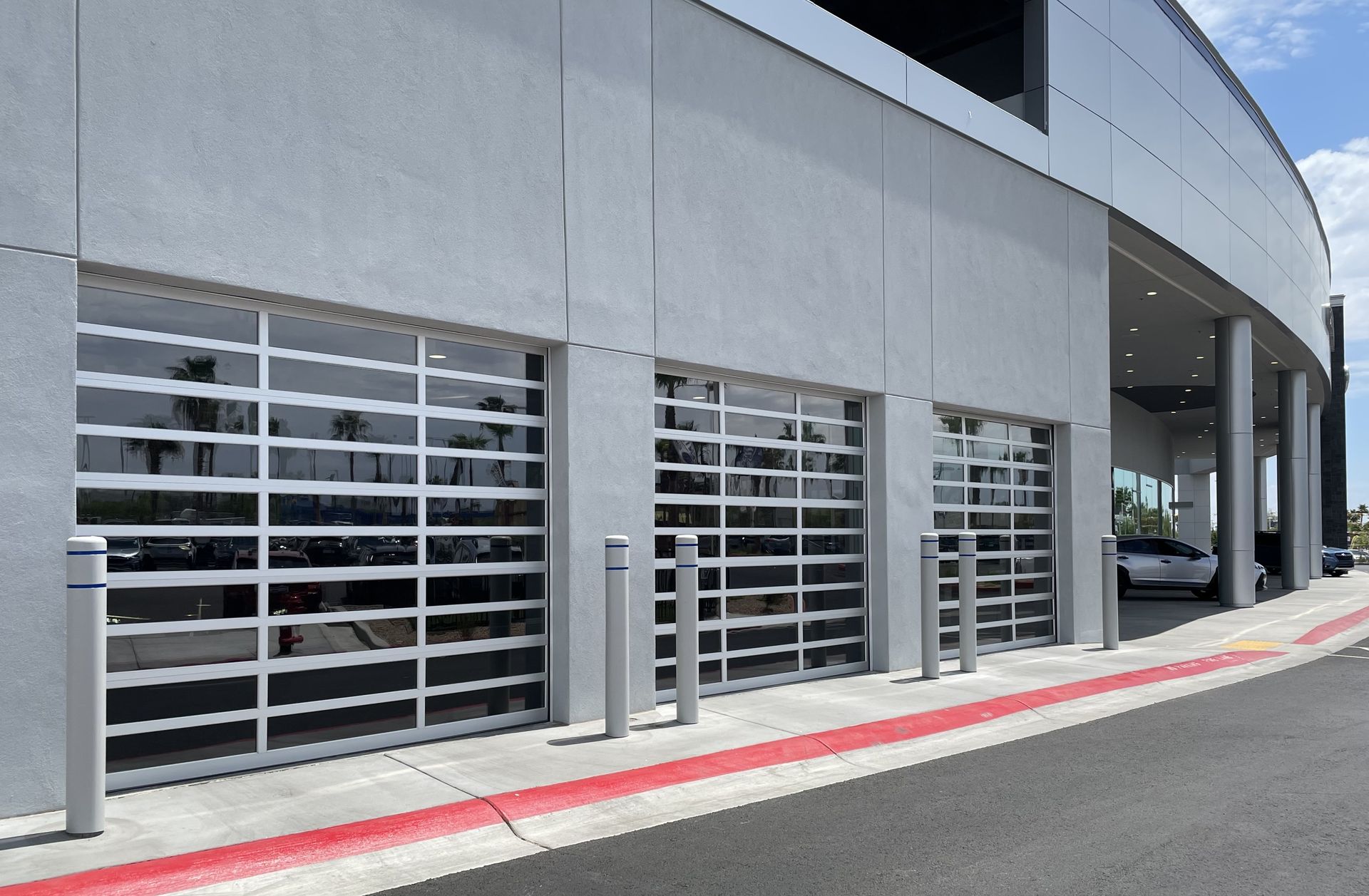 A car is parked in a garage next to a building