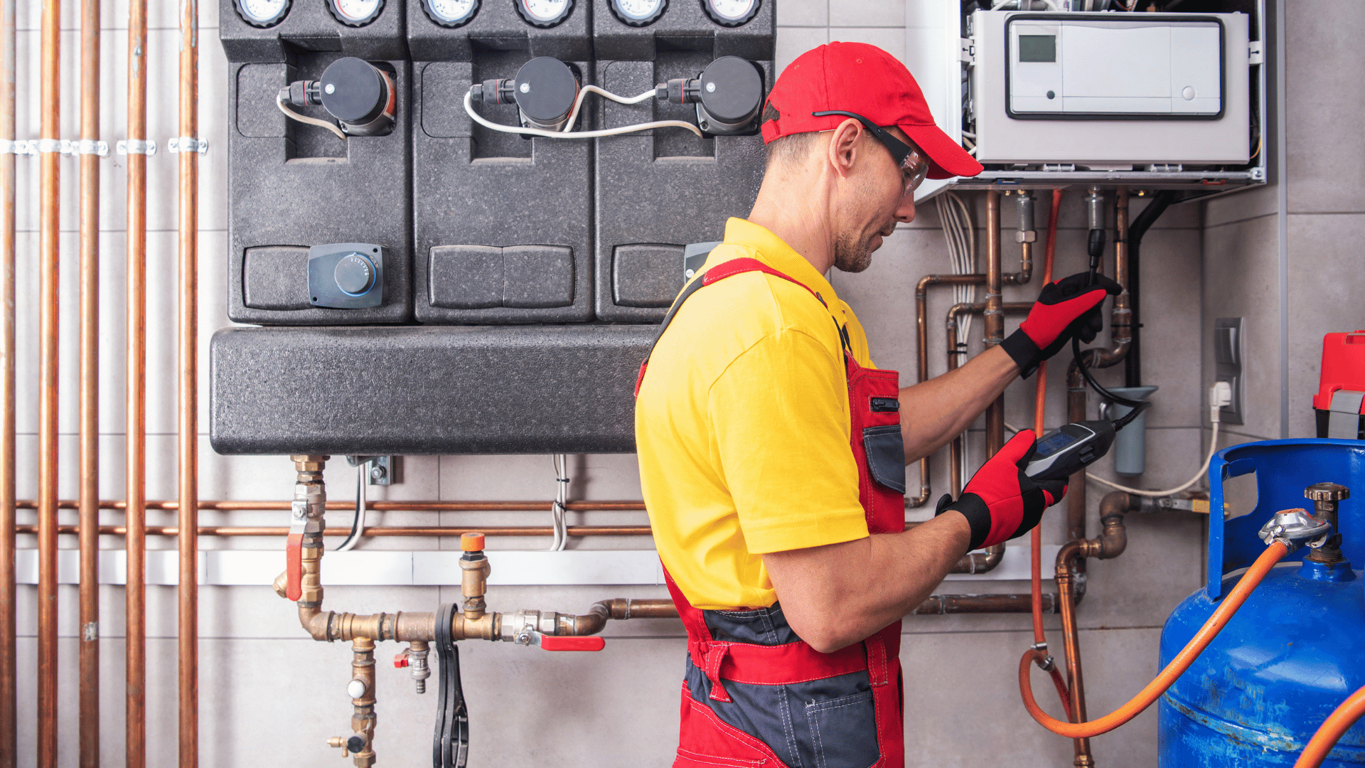 A man is working on a heating system in a room.