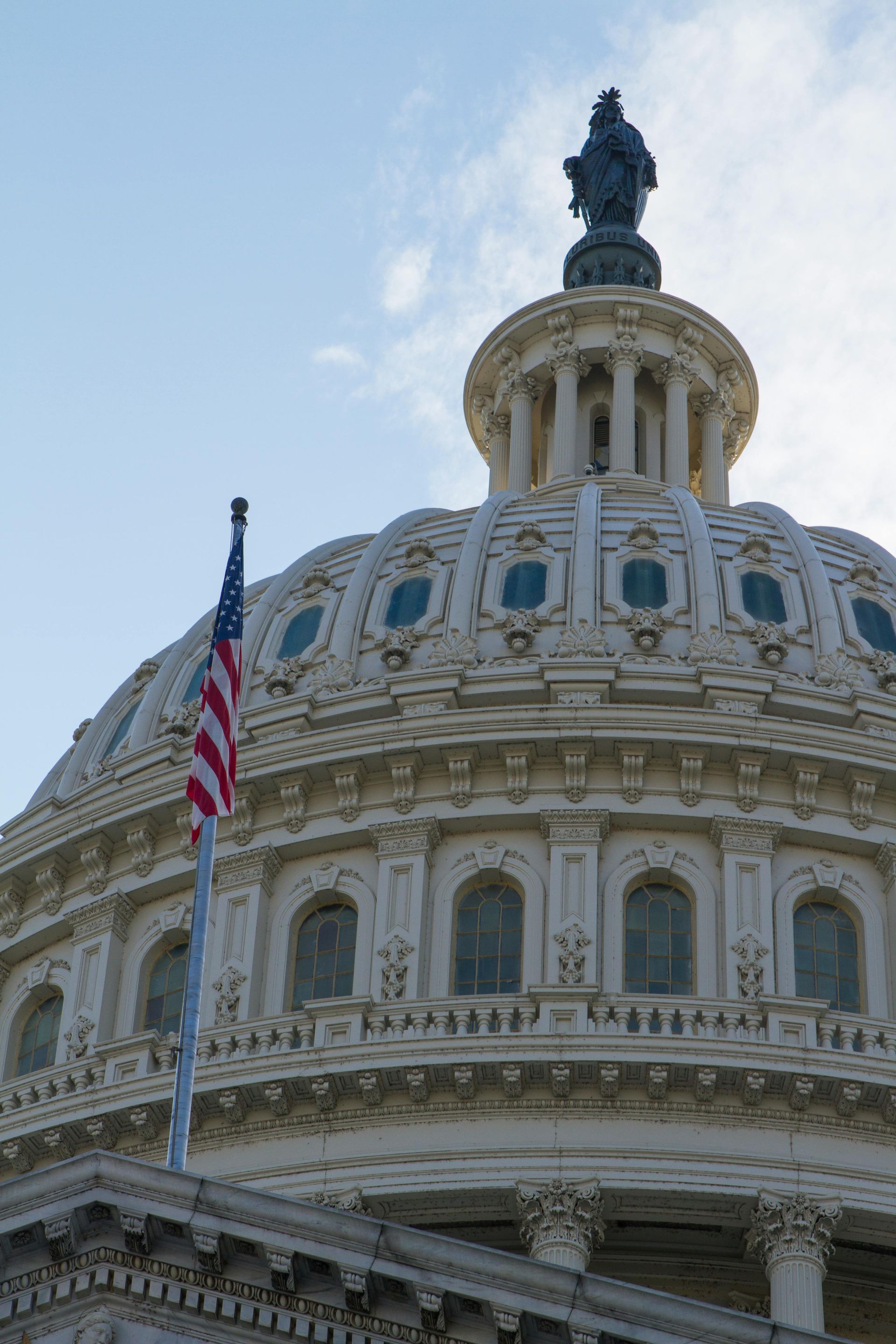 an American flag flies at the US Capitol