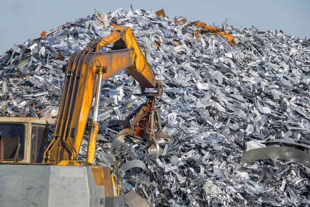 Yellow Excavator is Working on a Pile of Scrap Metal — Boland Contracting in Wellington, NSW