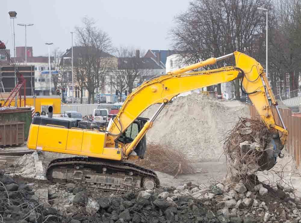 Yellow Excavator is Moving Dirt and Rocks — Boland Contracting in Wellington, NSW