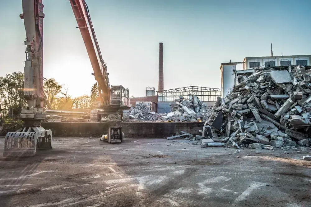Crane is Lifting a Pile of Metal in a Scrap Yard — Boland Contracting in Wellington, NSW