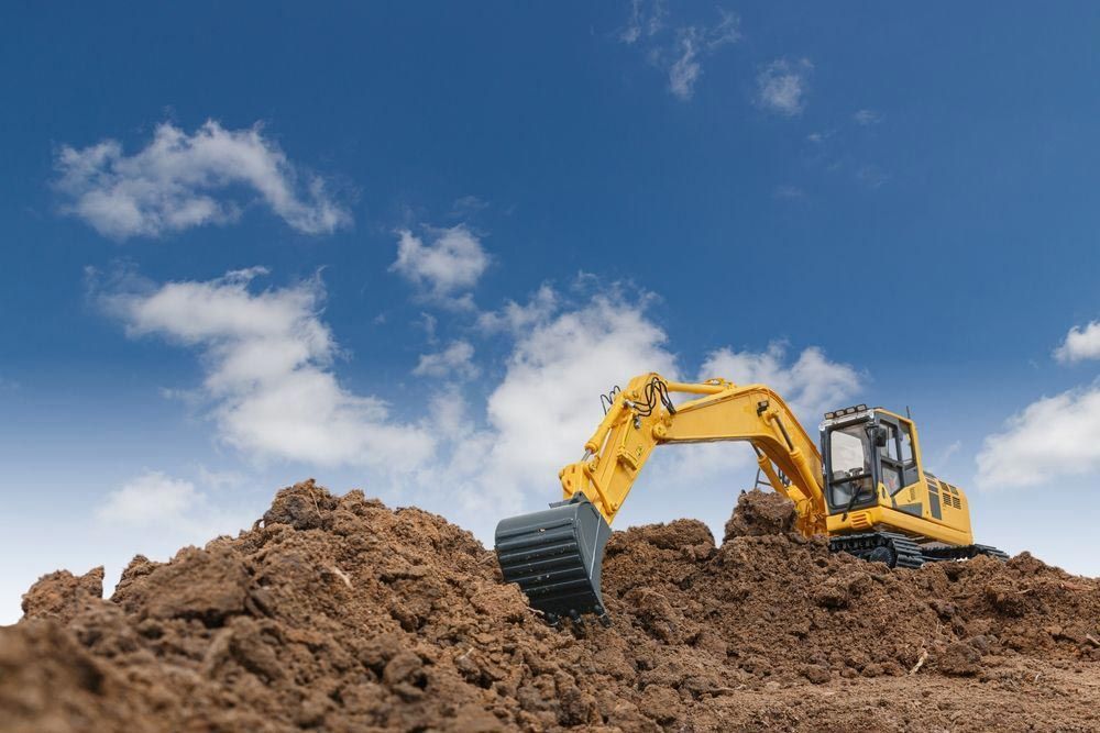 Yellow Excavator is Digging a Pile of Dirt — Boland Contracting in Wellington, NSW