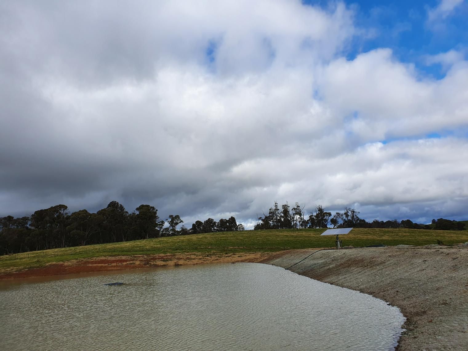 Cloudy Sky Over a Dirt Road With Trees — Peel Irrigation & Water Supplies in Tamworth, NSW