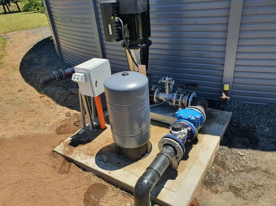 Water Pump is Sitting on Top of a Concrete Platform Next to a Building — Peel Irrigation & Water Supplies in Taminda, NSW
