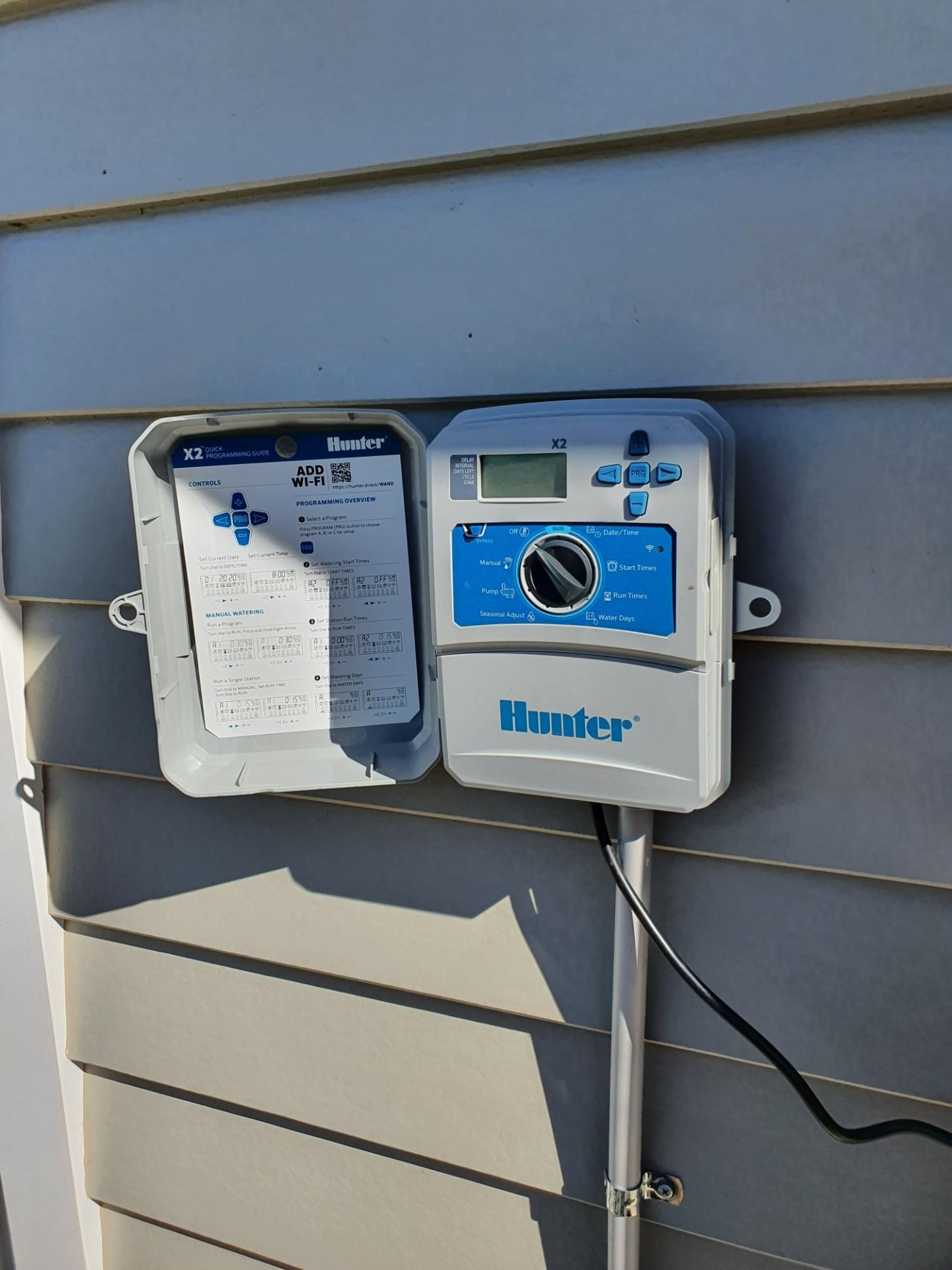 Sprinkler Controller is Sitting on the Side of a House — Peel Irrigation & Water Supplies in Taminda, NSW