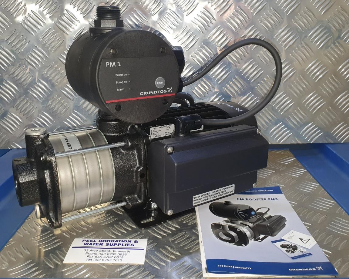 Water Pump is Sitting on a Table Next to a Manual — Peel Irrigation & Water Supplies in Tamworth, NSW